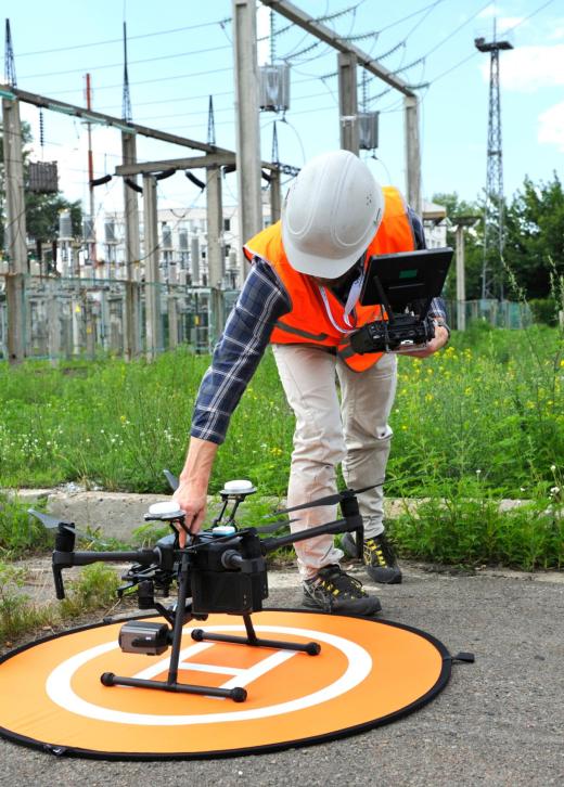 Operator adjusting quadcopter before launching it Operator adjusting quadcopter before launching it